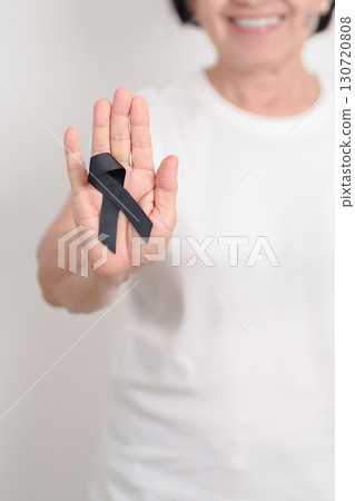 Elderly with Black ribbon for May Melanoma and skin cancer Awareness month, October Vaccine injury awareness month, Mourning Remembrance, March Sleep awareness week, Gang Prevention and Anti Violence 130720808