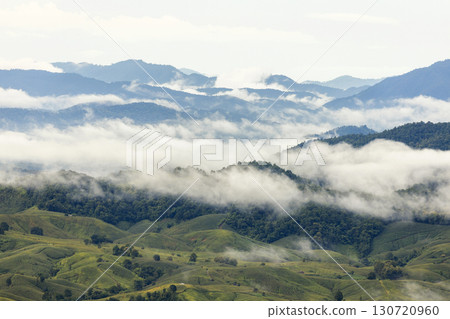 Landscape of Morning Mist with Mountain Layer. mountain ridge and clouds in rural jungle bush forest 130720960