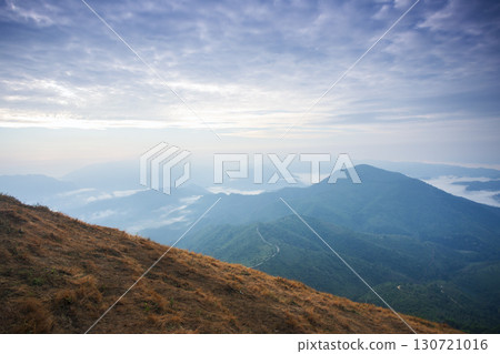 Landscape of Morning Mist with Mountain Layer. mountain ridge and clouds in rural jungle bush forest 130721016