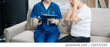 Asian caregiver doctor examine older patient woman therapist nurse at nursing home taking care of senior elderly woman sit on sofa.Medical service concept. 130722205