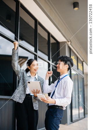 Businesswoman and man going in city center in smart casual business style, talking, working together, stylish 130722458