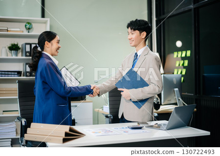 Two confident business man shaking hands during a meeting in the office, success, dealing, greeting and partner 130722493