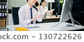 Two young Asian professionals engaged in teamwork and business discussions in modern office embodying corporate 130722626