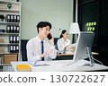 Two young Asian professionals engaged in teamwork and business discussions in modern office embodying corporate 130722627