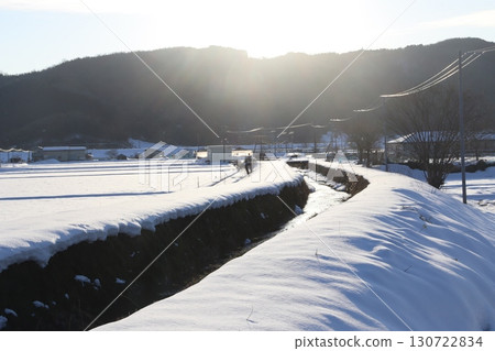Snowfield lit by the setting sun 130722834