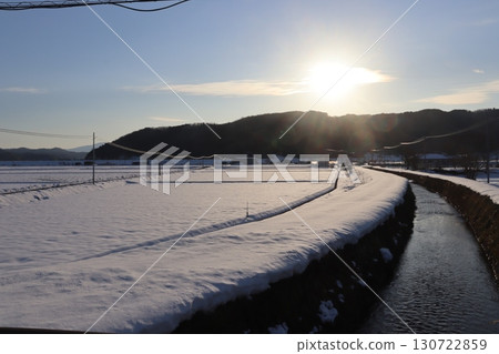Snowfield lit by the setting sun Snowfield lit by the setting sun 130722859