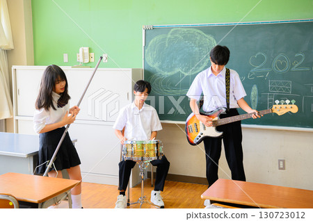 Students practicing in a band for the school festival. A youthful image in a school classroom. Students practicing in a band for the school festival. A youthful image in a school classroom. 130723012