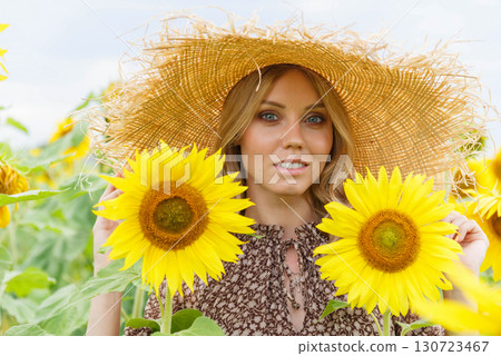 Portrait of a pretty girl in a field of sunflowers. 130723467
