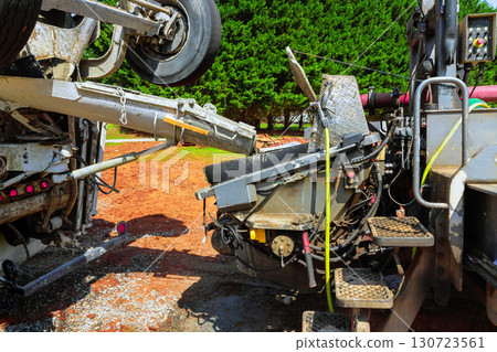 Construction workers are using mixes concrete machinery to transport concrete Construction workers are using mixes concrete machinery to transport concrete 130723561