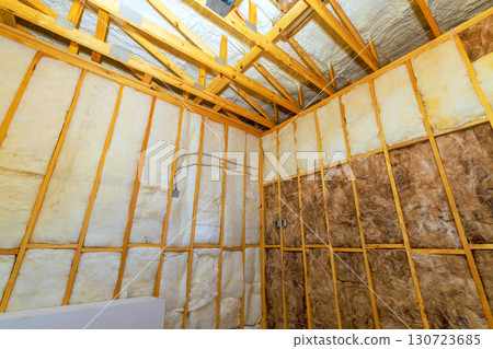 Workers insulate room with soundproofing material in new home build during works daytime preparations. 130723685