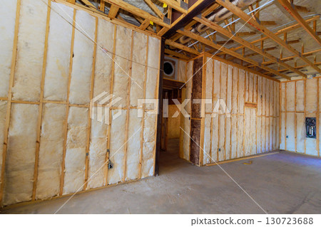 Exposed walls in home during renovation installation insulation, framing, revealing work in progress works time. 130723688