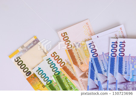Different South Korean won banknotes of various denominations displayed together 130723696