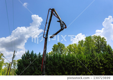 Construction mix truck lifts concrete pump high above for pouring wet cement work in works constructed day 130723699
