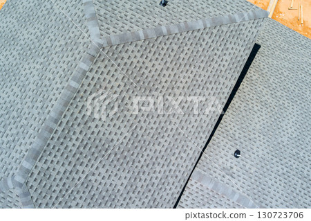 New roof design in natural light, highlighting geometric patterns construction materials. New roof design in natural light, highlighting geometric patterns construction materials. 130723706