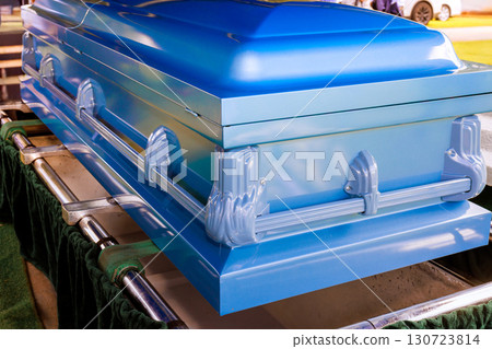 Blue casket is prominently placed at memorial cemetery during solemn funeral ceremony 130723814