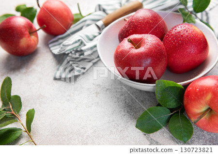 Fresh red apples resting in bowl on marble countertop 130723821