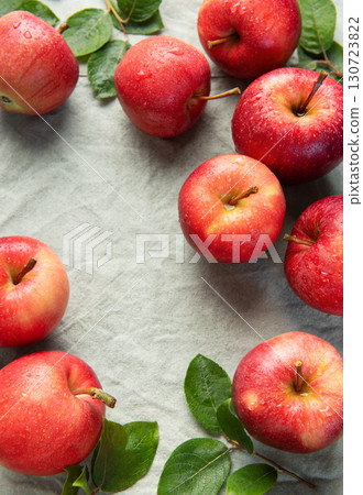 Fresh red apples forming a border on gray linen cloth Fresh red apples forming a border on gray linen cloth 130723822