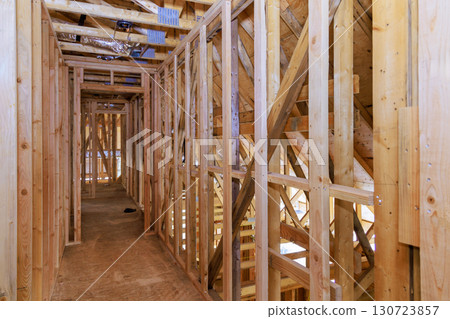 Construction wooden frames of residential interior with unfinished walls during works day. 130723857