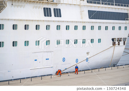 Crew members and large passenger ship docking 130724348
