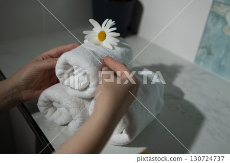 Creating a Decorative Towel Display With a Flower Accent on a Countertop Creating a Decorative Towel Display With a Flower Accent on a Countertop 130724737