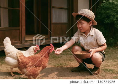 A scene from the Showa era: A child feeding chickens 130724926
