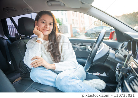 Portrait of young woman inside car interior. The car as a place in which a significant part of people lives passes Portrait of young woman inside car interior. The car as a place in which a significant part of people lives passes 130725021