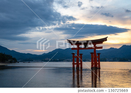 Famous red torii gate of Itsukushima shrine at sunset in Miyajima, Japan Famous red torii gate of Itsukushima shrine at sunset in Miyajima, Japan 130725669