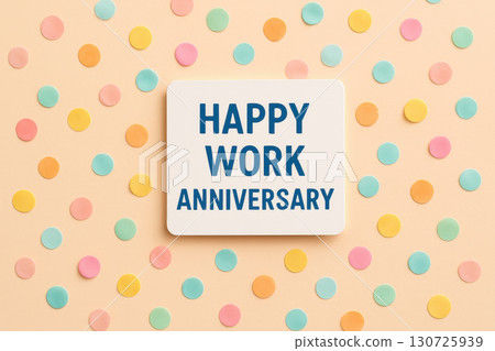 Happy work anniversary card with colorful confetti on pastel background creates cheerful and festive atmosphere perfect for celebrating joyful milestone at office or workplace 130725939