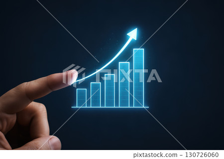 Financial growth and investment concept illustrated by glowing bar chart with upward arrow and hand pointing, symbolizing success and progress in finance and economy 130726060