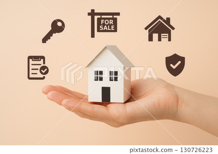 Hand holding small house model with business icons including key, for sale sign, home, checklist, and shield representing real estate, property investment, and security concepts Hand holding small house model with business icons including key, for sale sign, home, checklist, and shield representing real estate, property investment, and security concepts 130726223
