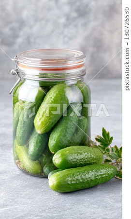 Close-up of a decorative jar brimming with fresh pickles, perfect for national pickle day celebrations Close-up of a decorative jar brimming with fresh pickles, perfect for national pickle day celebrations 130726530