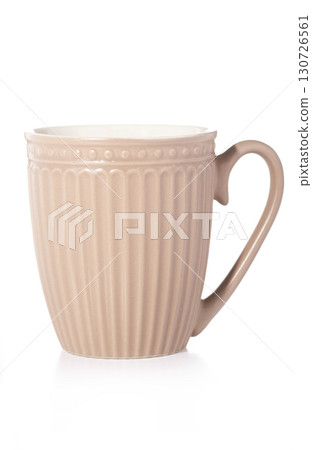 A single, elegant pink ceramic mug with a ribbed texture and a dotted rim, isolated on a white background, perfect for a cozy drink. A single, elegant pink ceramic mug with a ribbed texture and a dotted rim, isolated on a white background, perfect for a cozy drink. 130726561