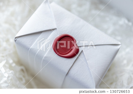 Wax seal stamp on white paper wrap packaging parcel box Wax seal stamp on white paper wrap packaging parcel box 130726653