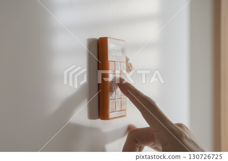A woman using a kitchen timer on the refrigerator A woman using a kitchen timer on the refrigerator 130726725