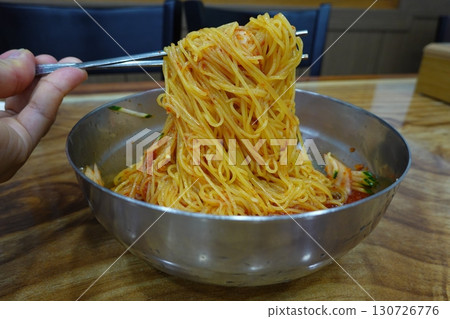 Authentic Pyongyang naengmyeon with chewy buckwheat noodles in cold, clear broth, offering a refreshing and delicate flavor. Perfect for traditional Korean cuisine menus and summer dishes. 130726776