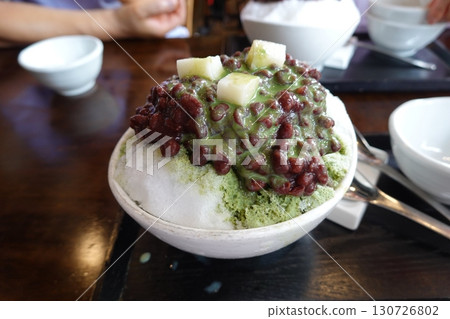 Refreshing patbingsu with fluffy shaved ice, sweet red bean paste, chewy rice cakes, and fresh fruit toppings. A classic Korean dessert, perfect for cooling down on hot days with a delightful taste! Refreshing patbingsu with fluffy shaved ice, sweet red bean paste, chewy rice cakes, and fresh fruit toppings. A classic Korean dessert, perfect for cooling down on hot days with a delightful taste! 130726802