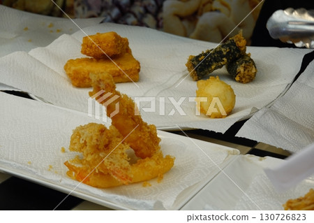 Crispy and delicious Twigim, Korean-style tempura with a variety of ingredients like vegetables and seafood, deep-fried to perfection. Enjoyed as a flavorful, crunchy street food. 130726823