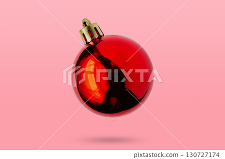 Red Christmas ball isolated on pink background 130727174