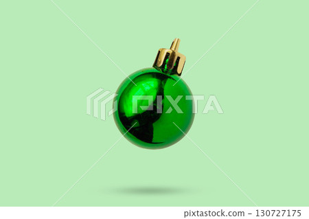 Green Christmas ball isolated on green background 130727175