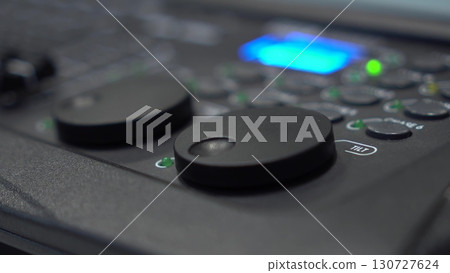 Close-up of finger adjusting Tilt shuttle on lighting console Close-up of finger adjusting Tilt shuttle on lighting console 130727624