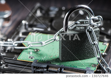 The hard drive is wrapped in metal chains, symbolizing reliable data protection. The hard drive is wrapped in metal chains, symbolizing reliable data protection. 130727646