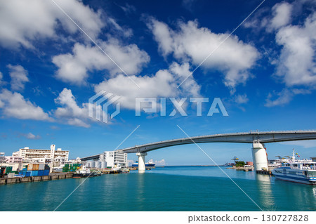A view of Naha Tomari Port from a departing ship. Tomari Bridge and Tomarin are visible. Naha Tomari Port, Naha City, Okinawa Prefecture - June 26, 2025 130727828