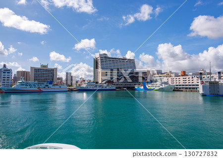 A view of Naha Tomari Port from a departing ship. Tomari Bridge and Tomarin are visible. Naha Tomari Port, Naha City, Okinawa Prefecture - June 26, 2025 A view of Naha Tomari Port from a departing ship. Tomari Bridge and Tomarin are visible. Naha Tomari Port, Naha City, Okinawa Prefecture - June 26, 2025 130727832