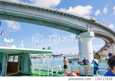 A view of Naha Tomari Port from a departing ship. Tomari Bridge and Tomarin are visible. Naha Tomari Port, Naha City, Okinawa Prefecture - June 26, 2025 A view of Naha Tomari Port from a departing ship. Tomari Bridge and Tomarin are visible. Naha Tomari Port, Naha City, Okinawa Prefecture - June 26, 2025 130727839