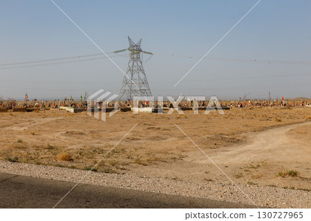 Traditional cemetery with colorful flags on graves in a desert landscape in Kunduz Afghanistan Traditional cemetery with colorful flags on graves in a desert landscape in Kunduz Afghanistan 130727965