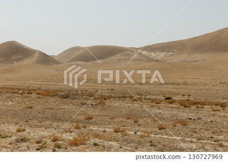 A vast and arid desert landscape with sandy hills and sparse vegetation in Kunduz Afghanistan A vast and arid desert landscape with sandy hills and sparse vegetation in Kunduz Afghanistan 130727969