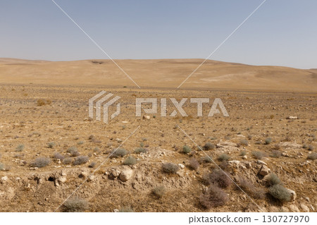 Desert landscape of Kunduz Province in Afghanistan with sparse vegetation under a hot hazy sky Desert landscape of Kunduz Province in Afghanistan with sparse vegetation under a hot hazy sky 130727970