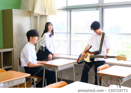 Students practicing in a band for the school festival. A youthful image in a school classroom. Students practicing in a band for the school festival. A youthful image in a school classroom. 130728771