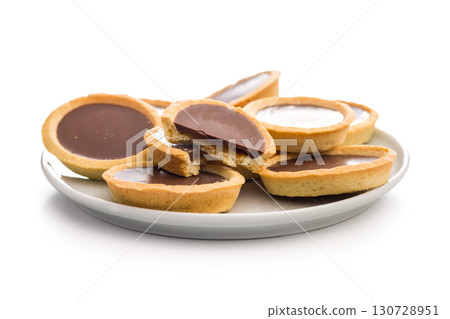 Sweet chocolate tartelettes isolated on white background. 130728951