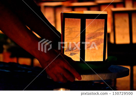 Hands of a person floating a lantern at the Manto-e festival in the Houoden Hall of the Nishinobo temple of Kurigara Fudo-ji Temple 130729500